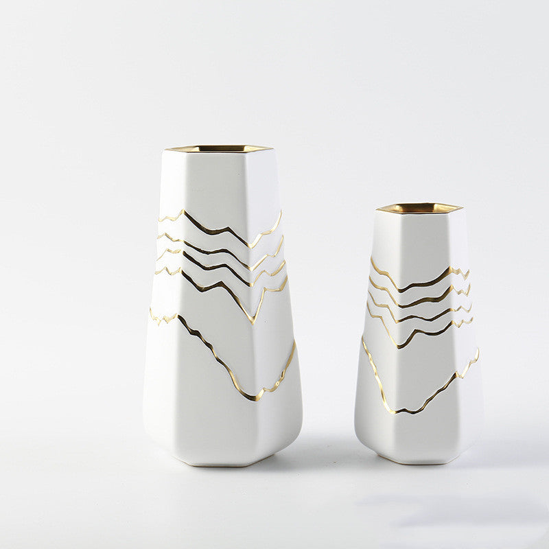 White ceramic hexagonal vase with gold wave patterns standing