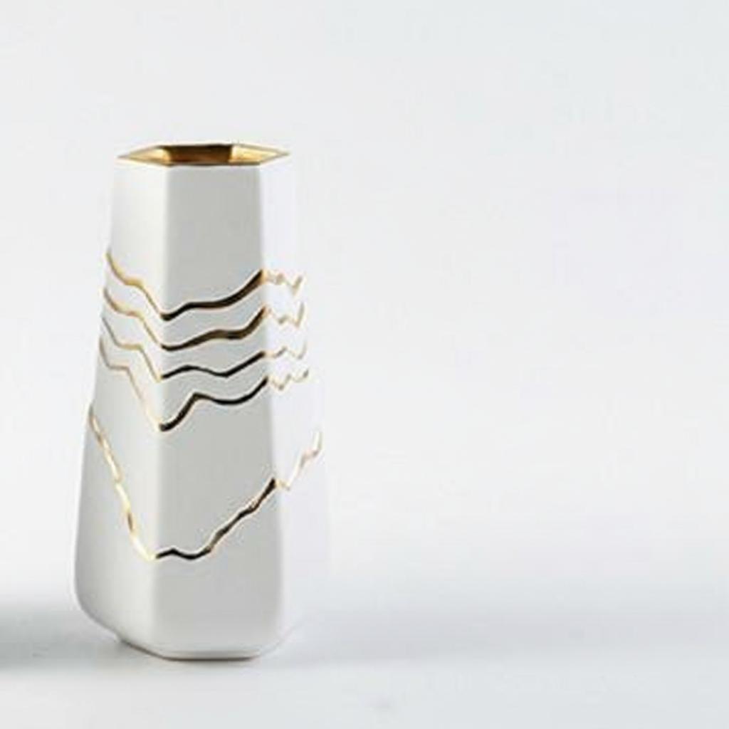 Detail view of gold rim and wave pattern on ceramic vase