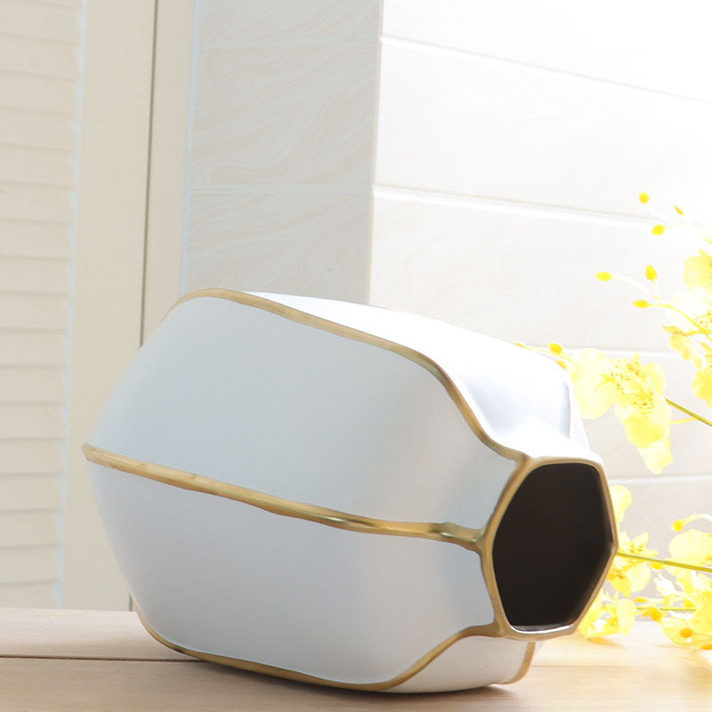Top angle view of medium white and gold vase