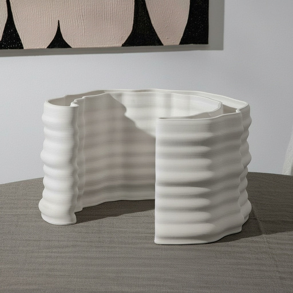 White Ceramic Ribbed Curved Sculpture on a textured table