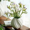 White Ceramic Swirled Vase Styled With Flowers