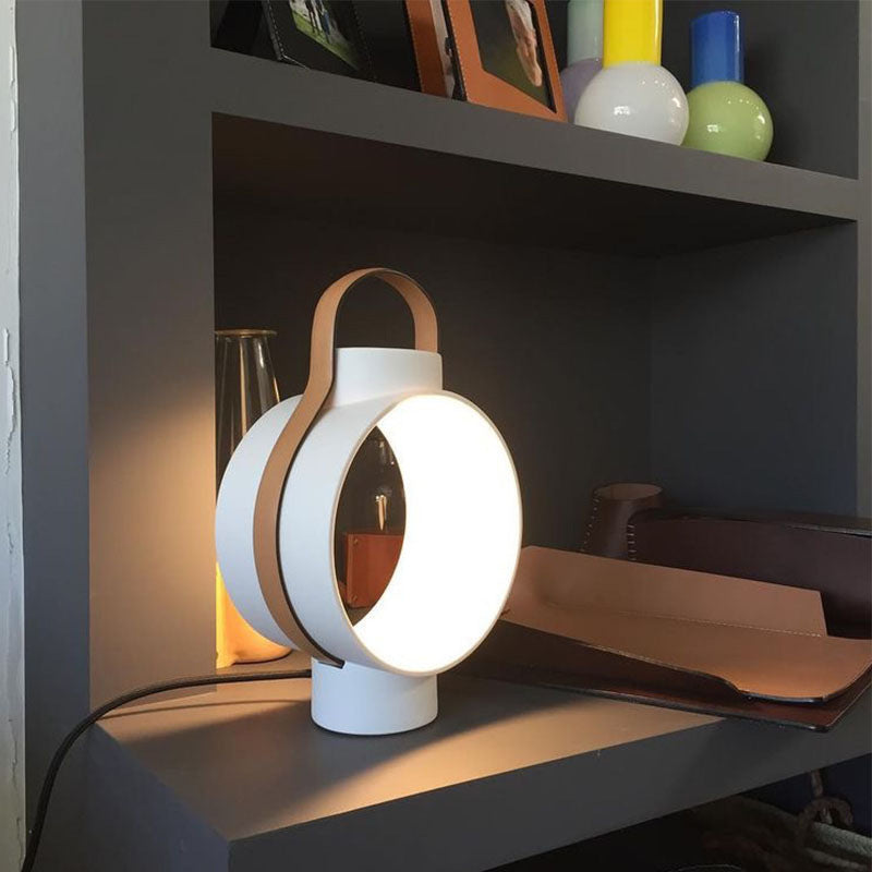 Modern white lantern lamp on dark shelf