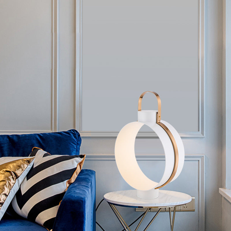 White and brass circular lamp in blue living room