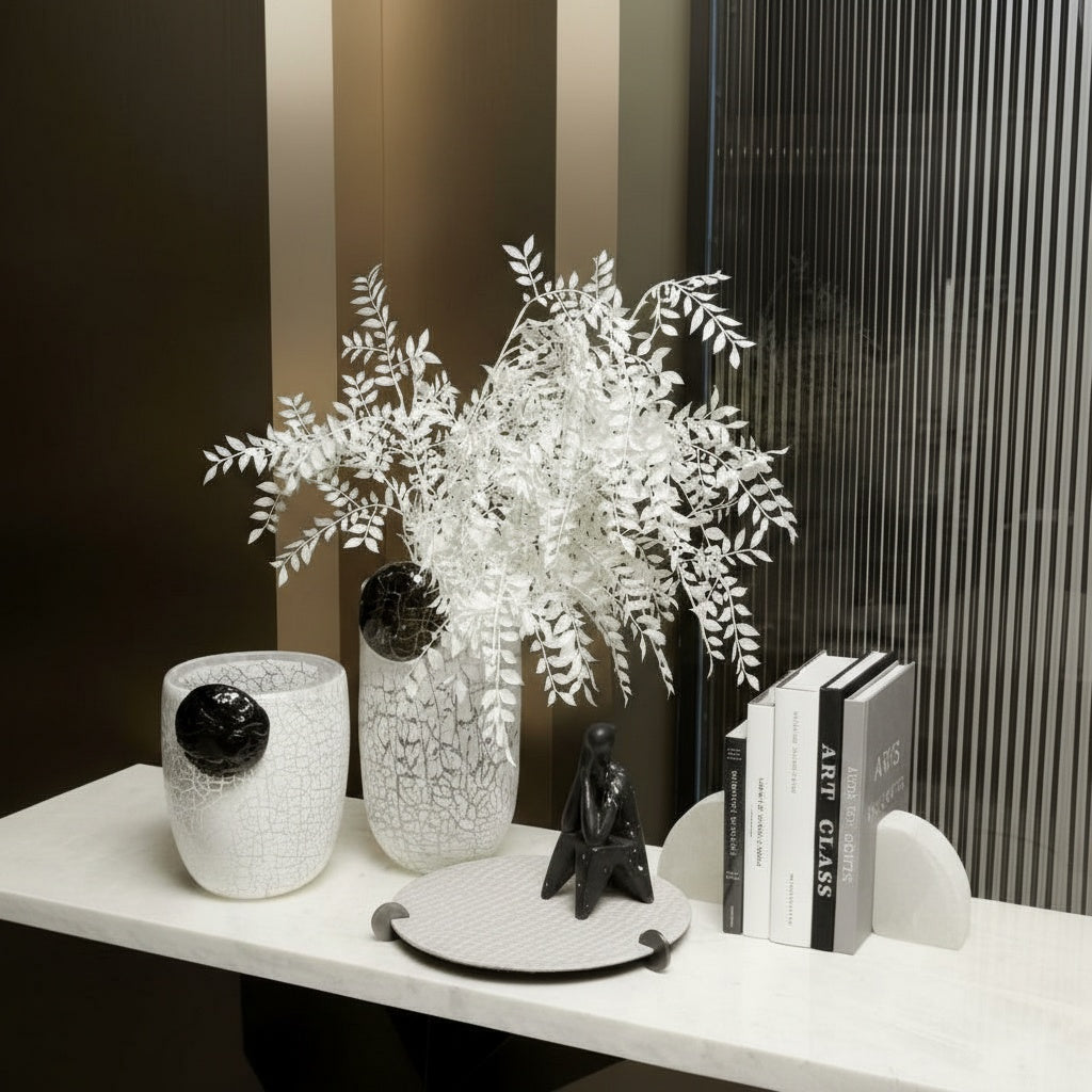 Styled console table with white crackle vases and books