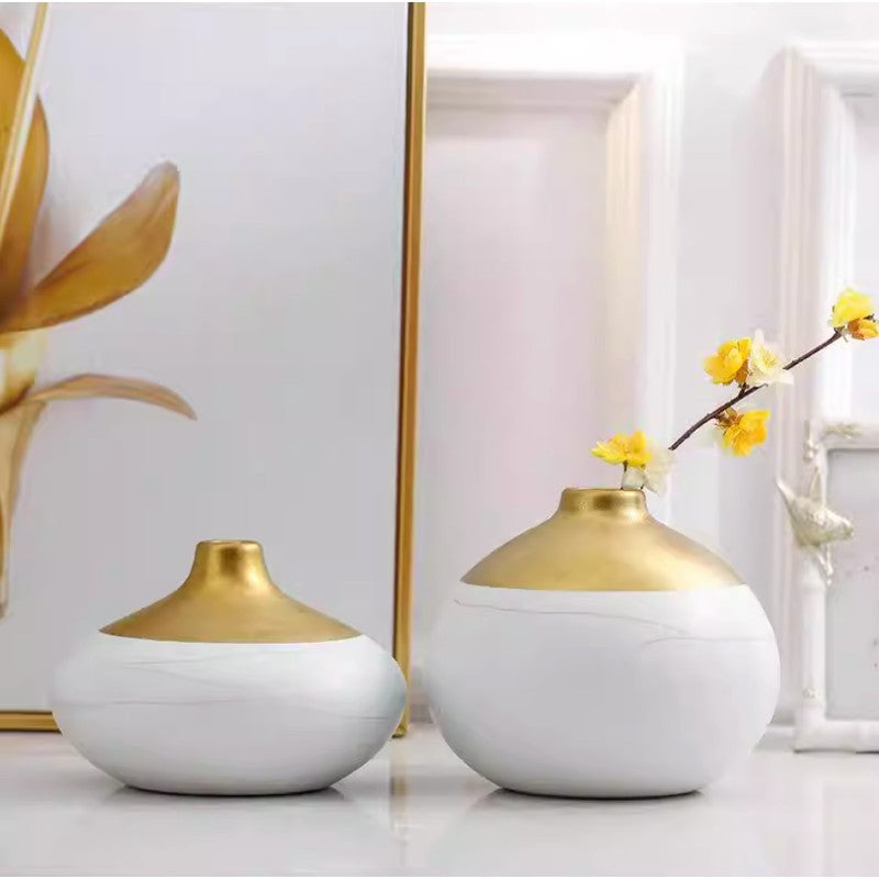 Modern white and gold vase with flower arrangement on table minimalist decor styling