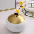 Detail of gold dipped top finish on white porcelain vase premium decor design