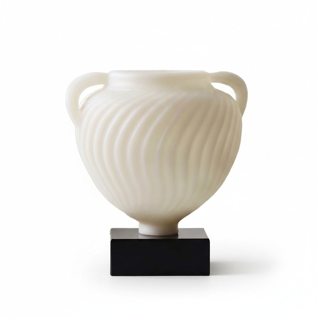 Front view of white fluted swirl urn vase on black plinth