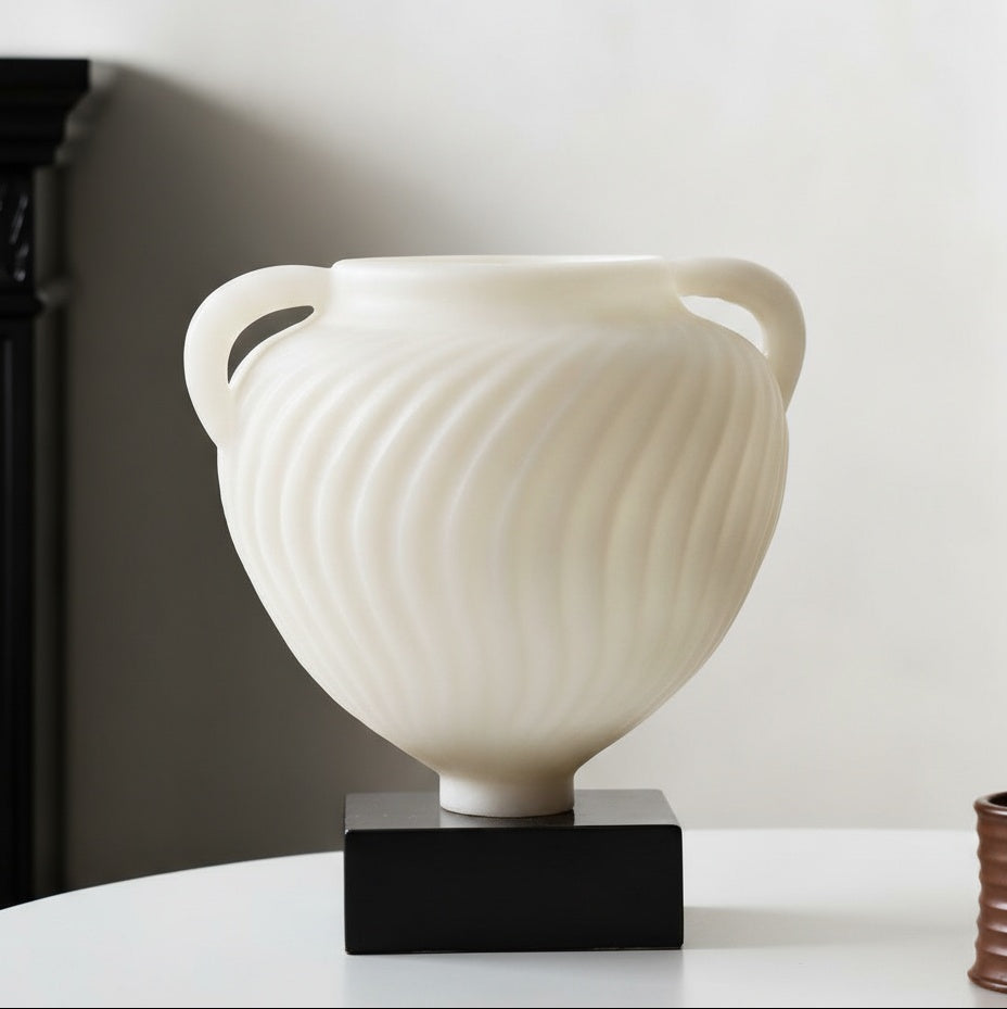 Angled view of empty white fluted vase showing frosted texture