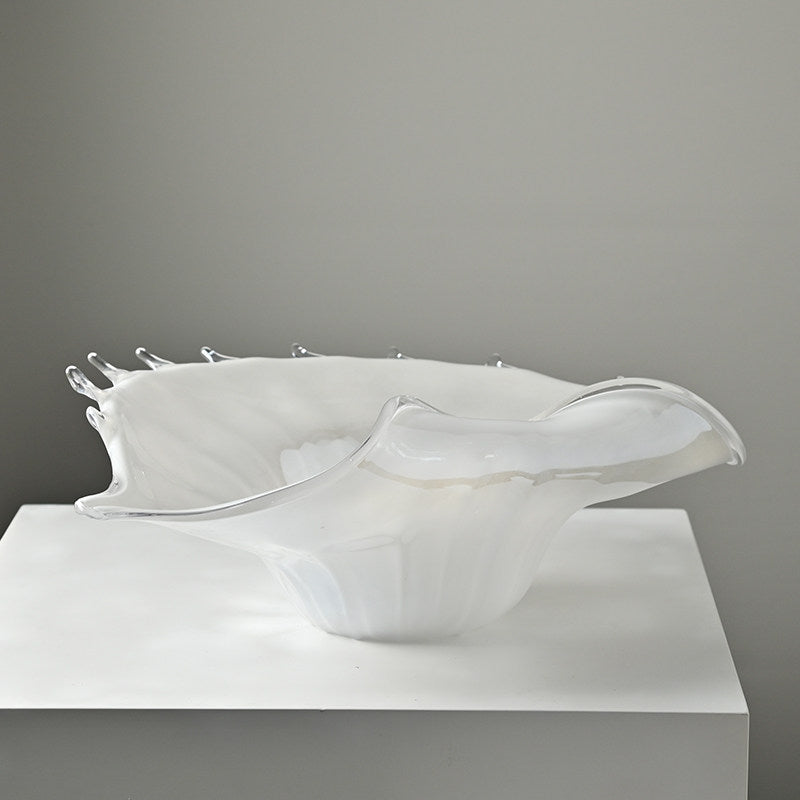 Angled view of sculptural glass seashell bowl
