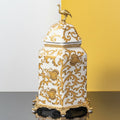 Large white and gold ornate ceramic jar on stand
