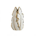 Decorative vase shaped like a feather with gold accents on a white background