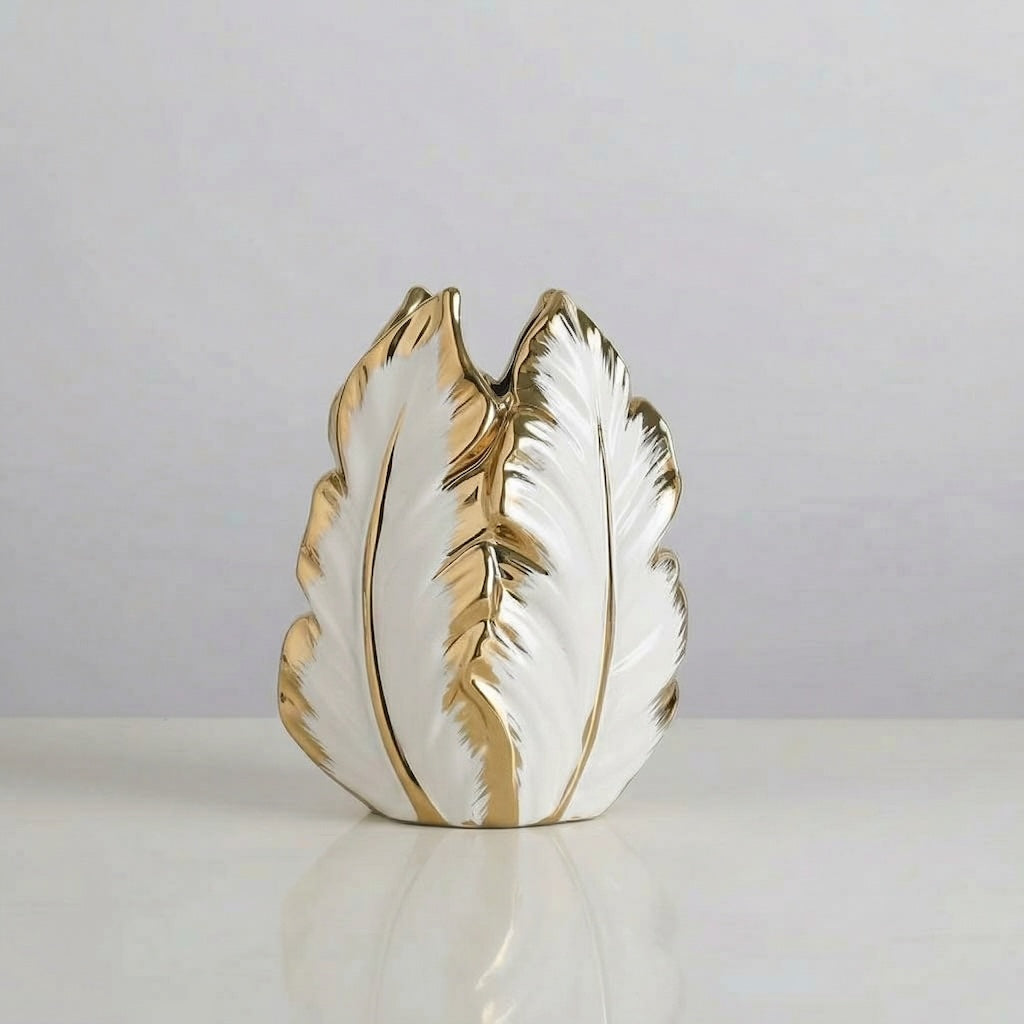 Decorative vase with gold and white feather design on a light gray background