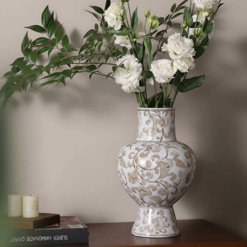 White and gold ceramic floral vase with fresh flowers on sideboard
