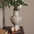 Detail of white and gold patterned ceramic vase