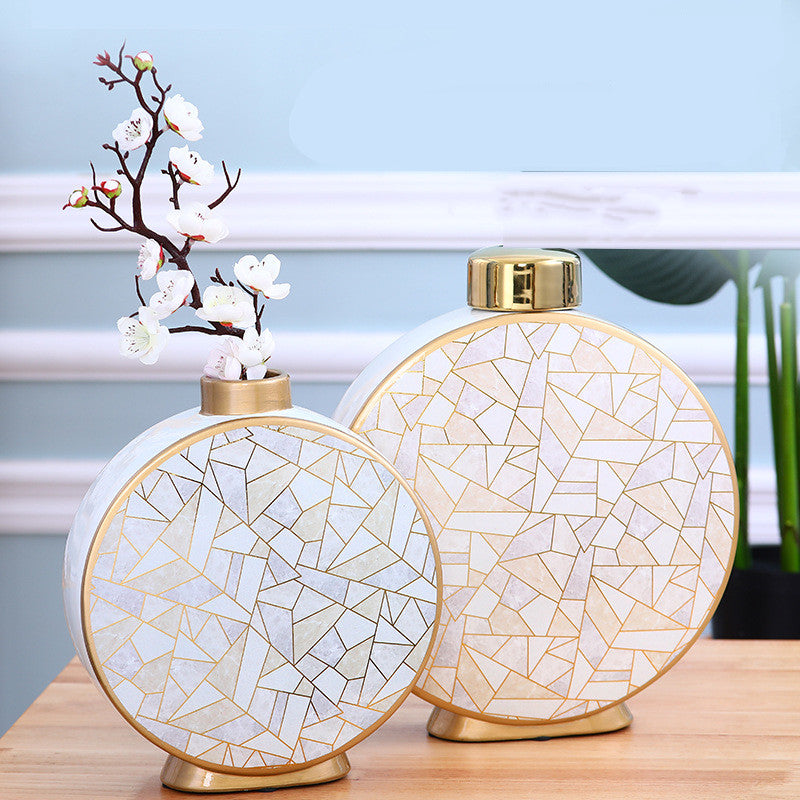 Medium vase with floral arrangement next to large vase