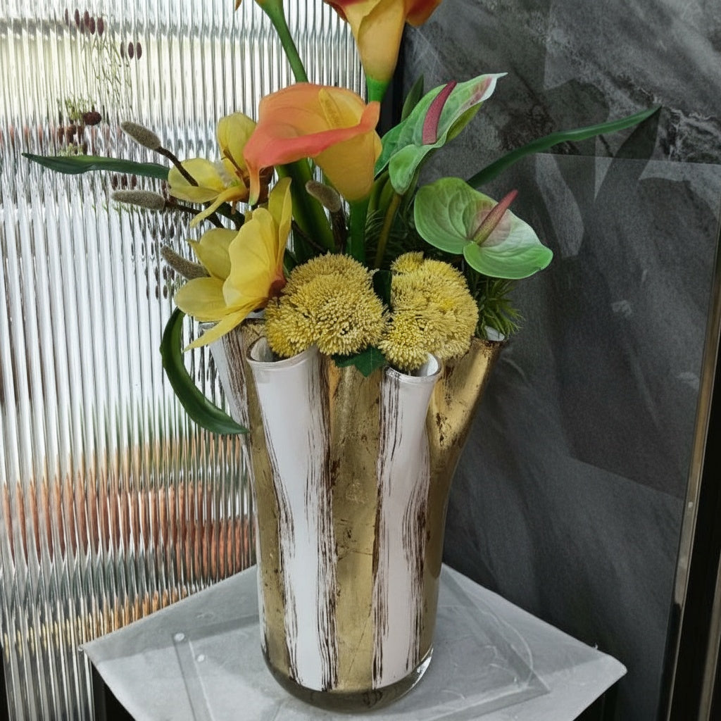 White and gold leaf glass vase with floral arrangement