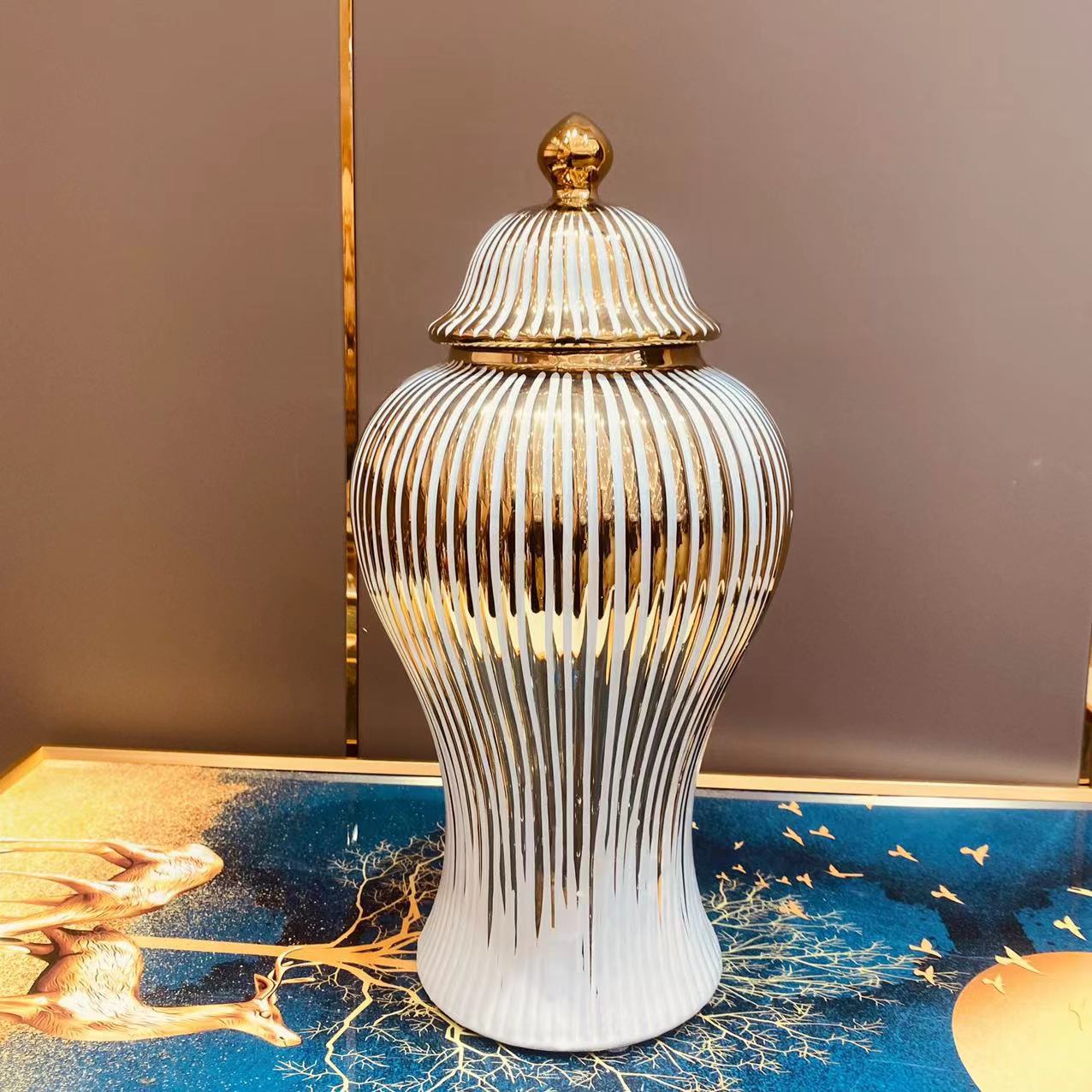 White ceramic temple jar with vertical gold stripes