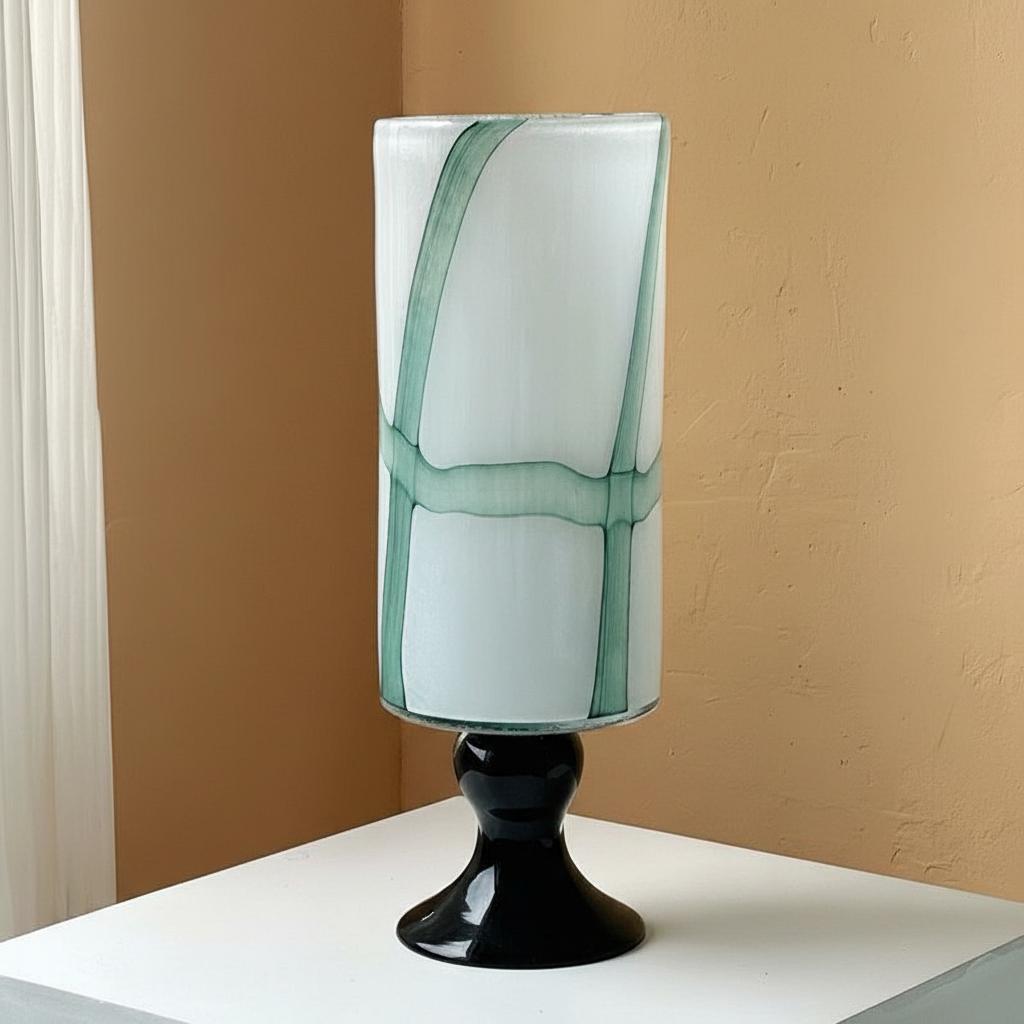 Front view of large white and green glass pedestal vase