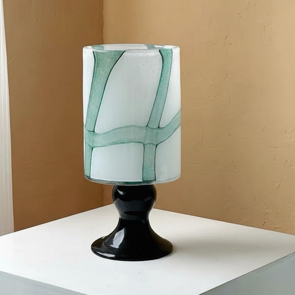 Front view of medium white and green glass pedestal vase