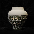 Front view of white and green textured ceramic vase showing openwork base