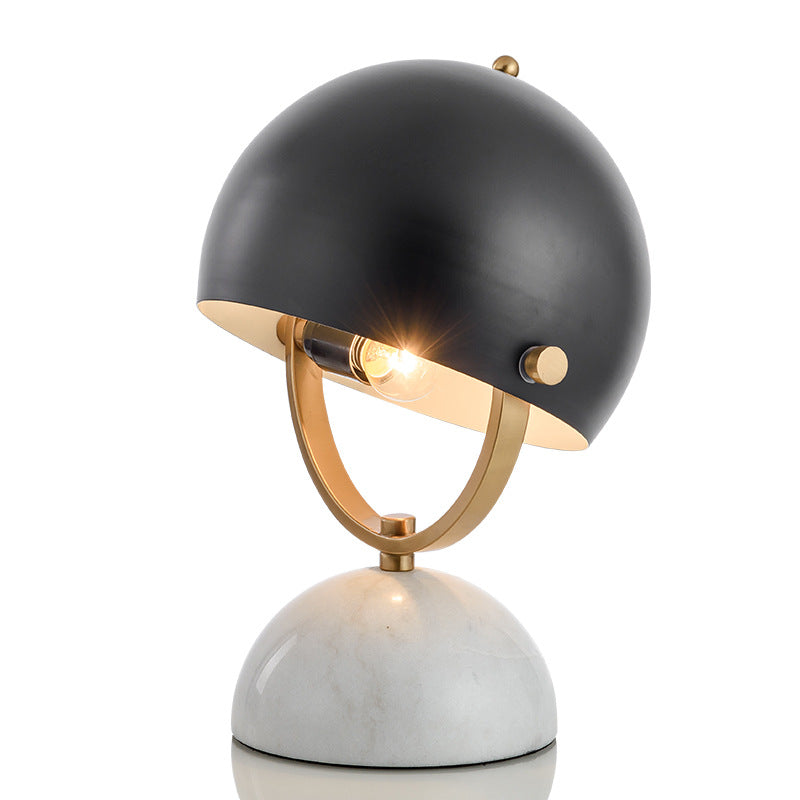 Studio shot of marble and black metal table lamp lit up
