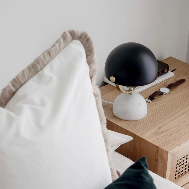 Lifestyle view of lamp on bedside table next to pillow