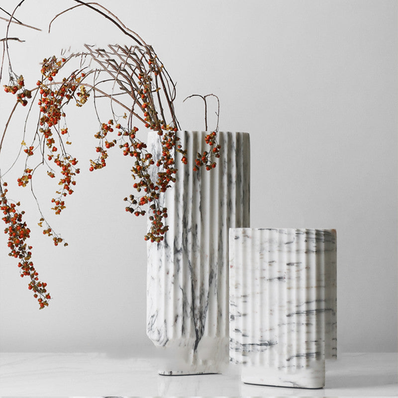 White marble fluted vase with floral arrangement