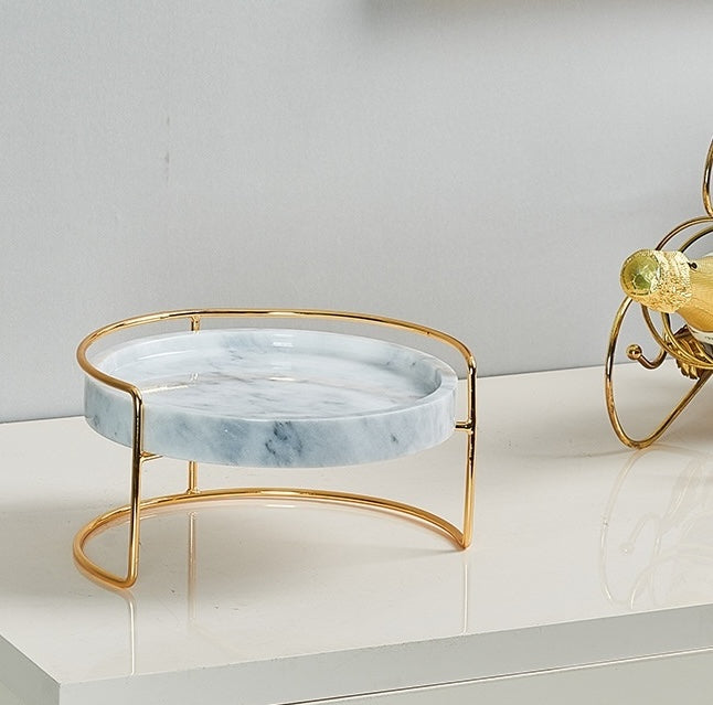 Angled view of elevated marble tray showing gold metal frame structure