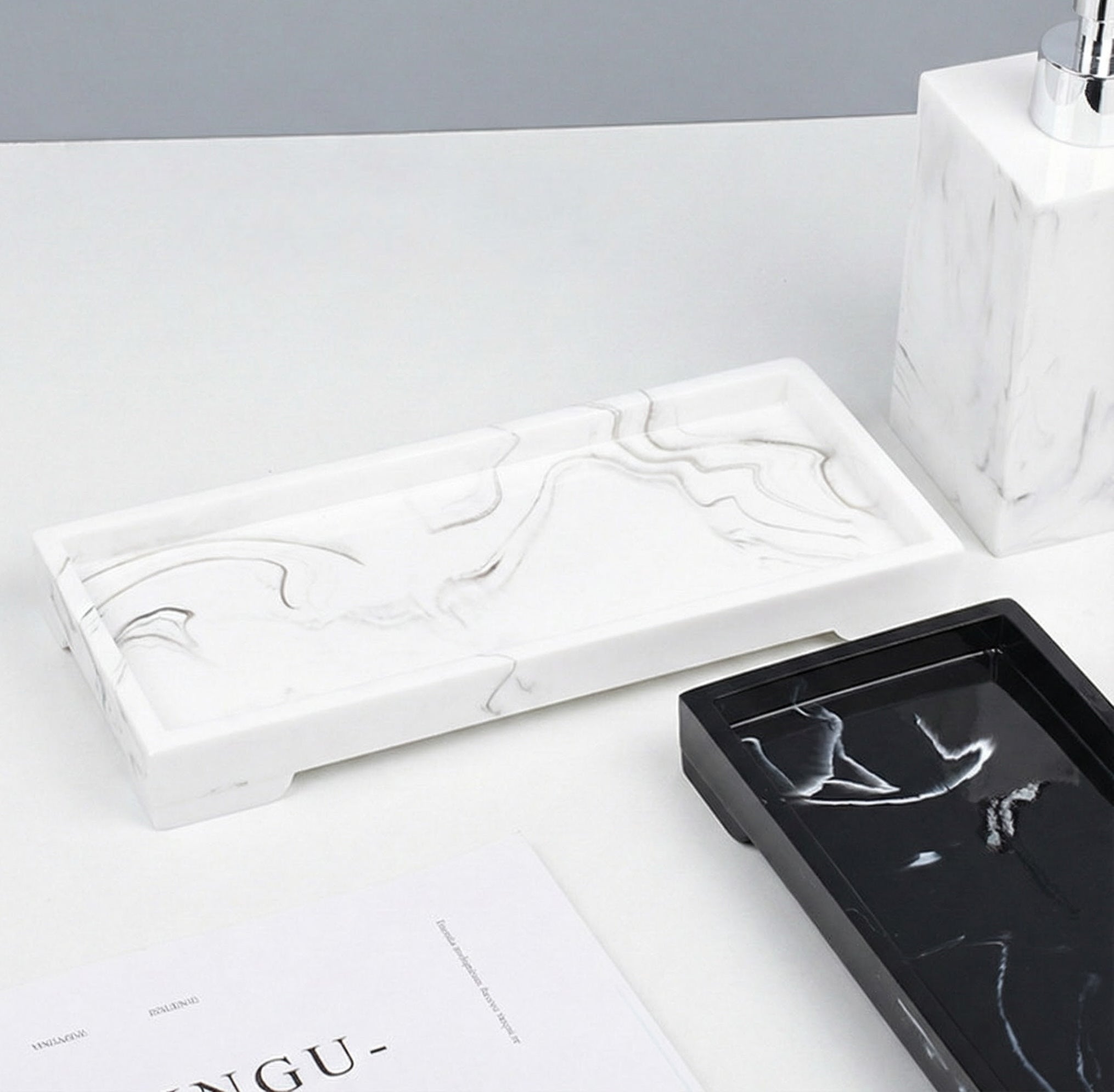 Close up of white resin bathroom tray with grey marble pattern