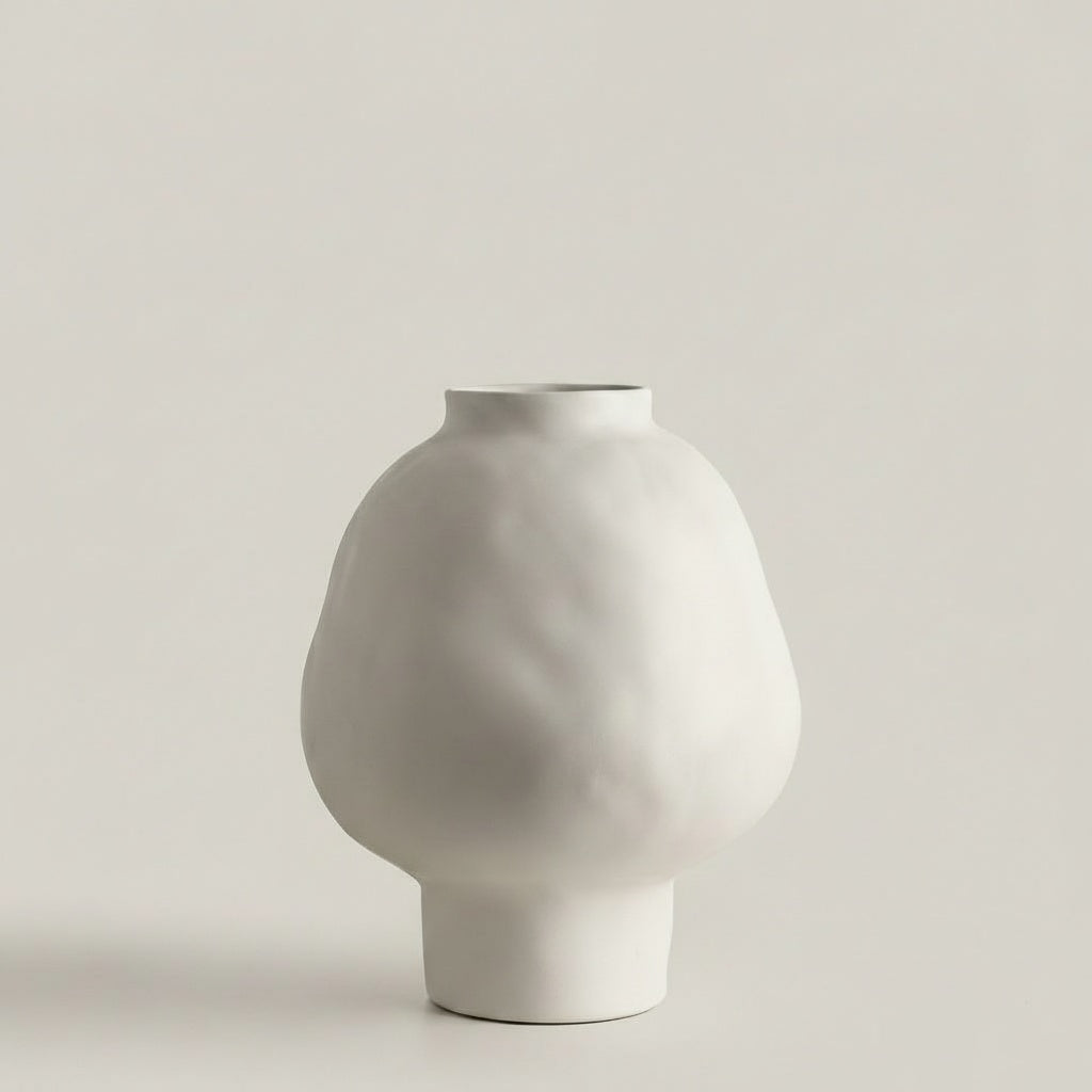 Front view of white matte ceramic bulbous vase on white background