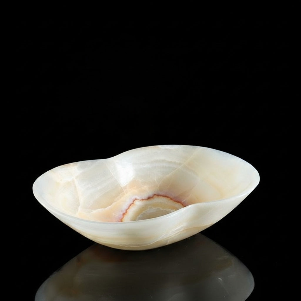 Side view of translucent white onyx bowl on black background