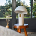 White painted iron mushroom table lamp on wooden stool