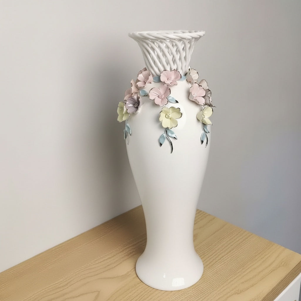 Full view of white ceramic vase with floral applique
