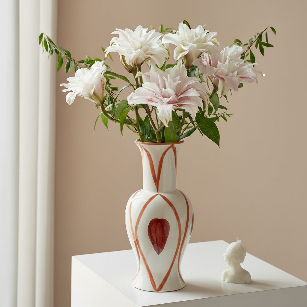 Lifestyle shot of geometric ceramic vase with lilies on white table