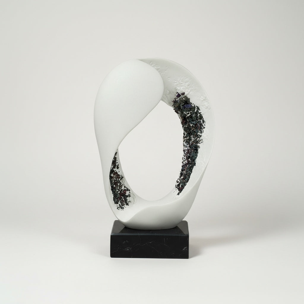 Angled view of matte white oval sculpture showing crystalline texture detail