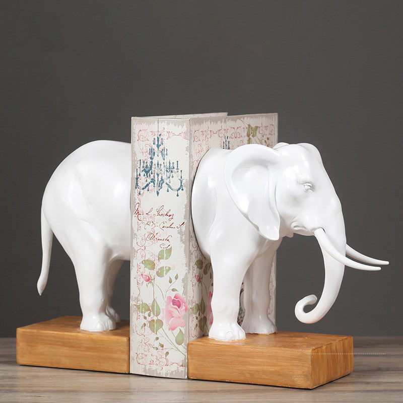 Elephant bookends separating books on a desk