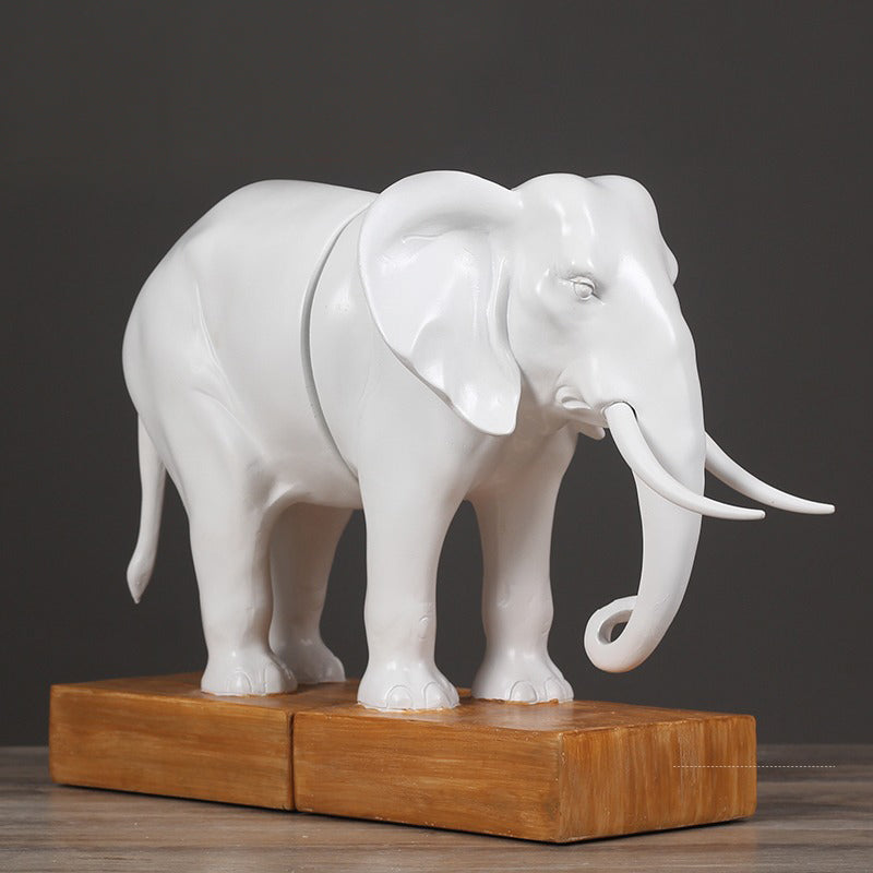 Angled view of elephant bookends joined on wooden base