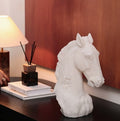White resin horse head sculpture on dark wood table