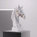 Side profile of white horse head sculpture with gold bridle
