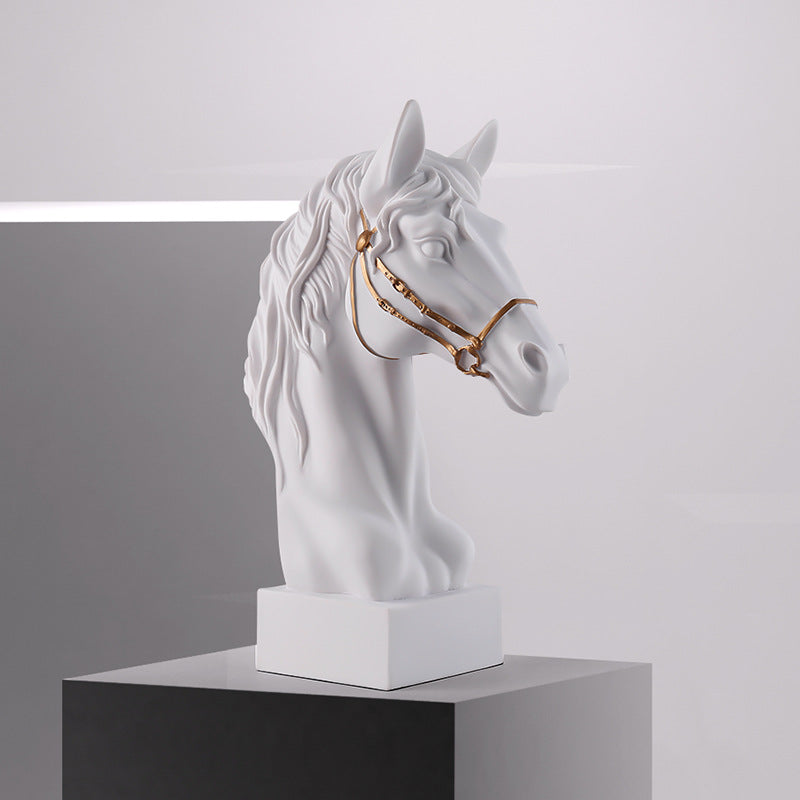Side profile of white horse head sculpture with gold bridle