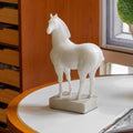 Side profile of white resin horse sculpture on marble base