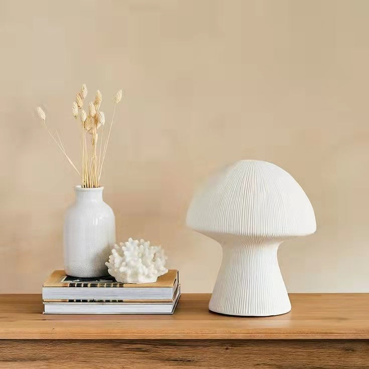 Unlit white resin mushroom lamp styled with vase