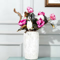 White speckled ceramic vase with flowers styled