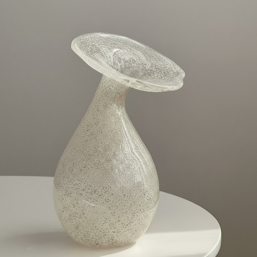 Side profile of bulbous white glass vase with wide rim