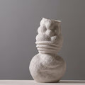 Detail of organic folded shape on white vase