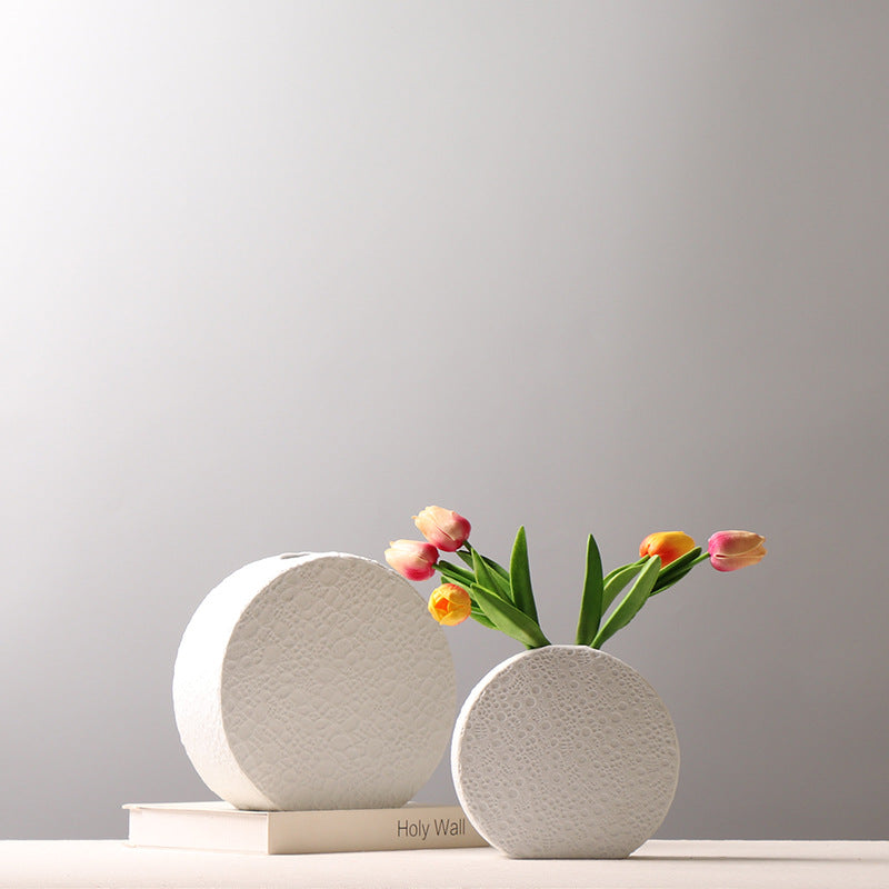 White textured ceramic round vase with tulips on table