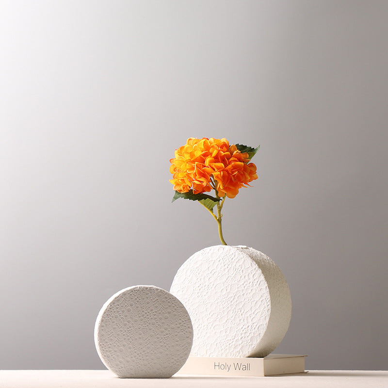 Set of two white round ceramic vases with lace texture