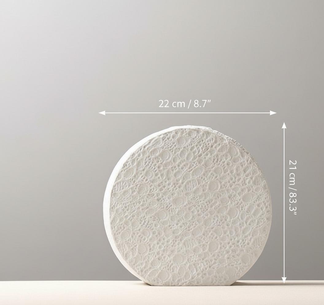 Front view of white textured ceramic disc vase