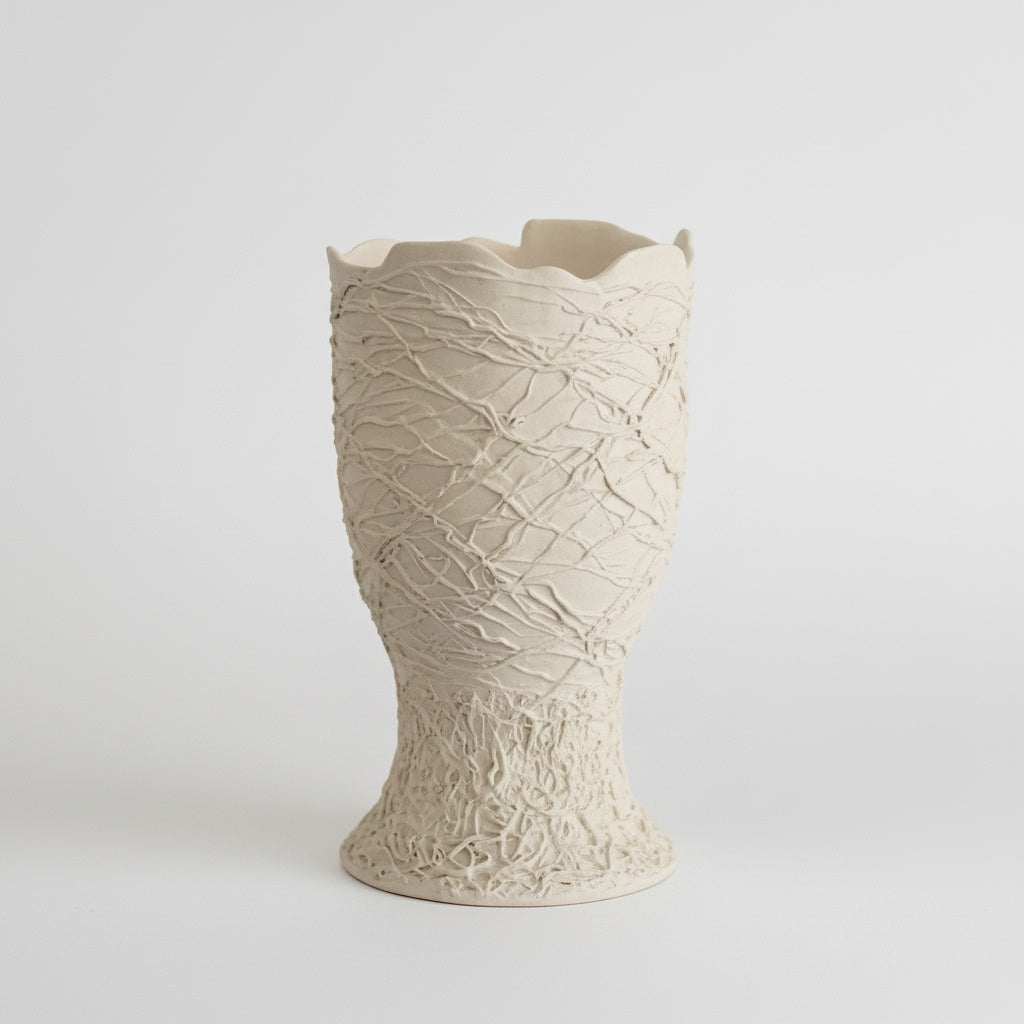 White textured ceramic sculptural vase isolated on a white background