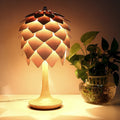 Illuminated pinecone table lamp with wood finish scales